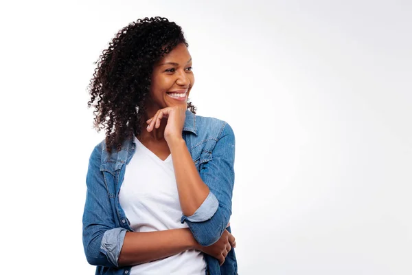 Cheerful woman posing while resting chin on hand — Stock Photo, Image