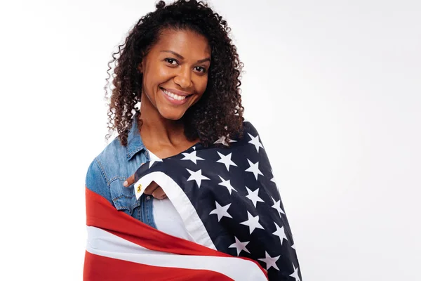 Счастливая женщина с флагом США на плечах — стоковое фото