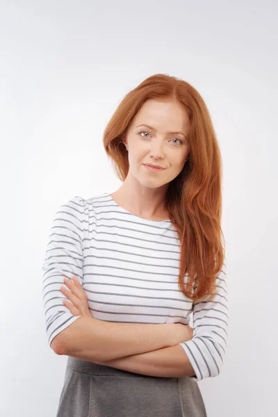 Ginger-haired woman posing with her arms folded — Stock Photo, Image