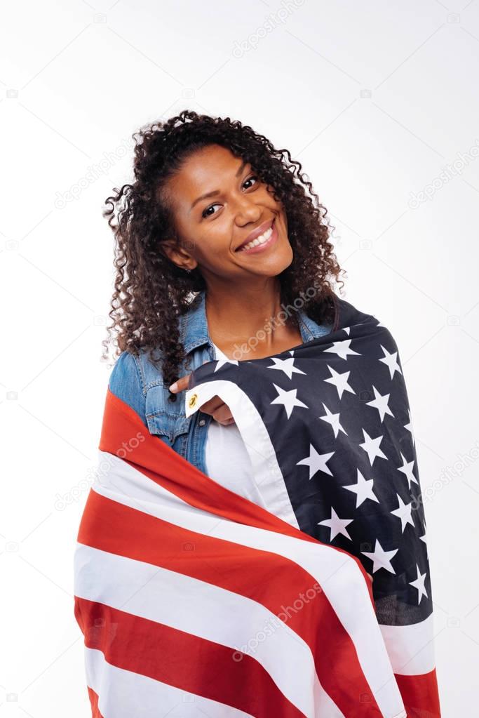 Curly brunette posing with American flag