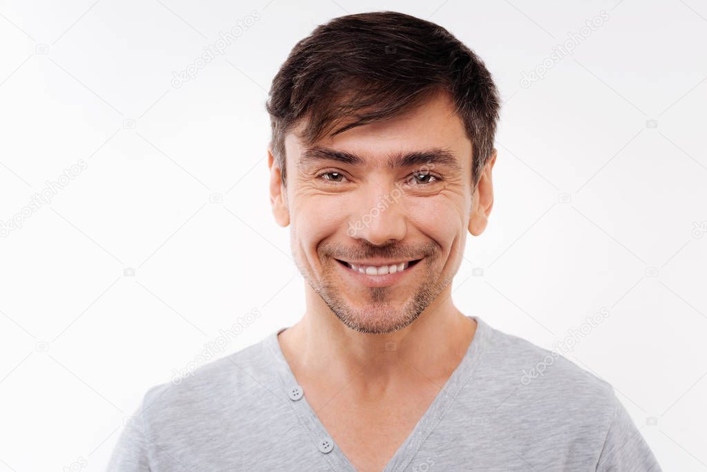 Pleasant cheerful man smiling at the camera