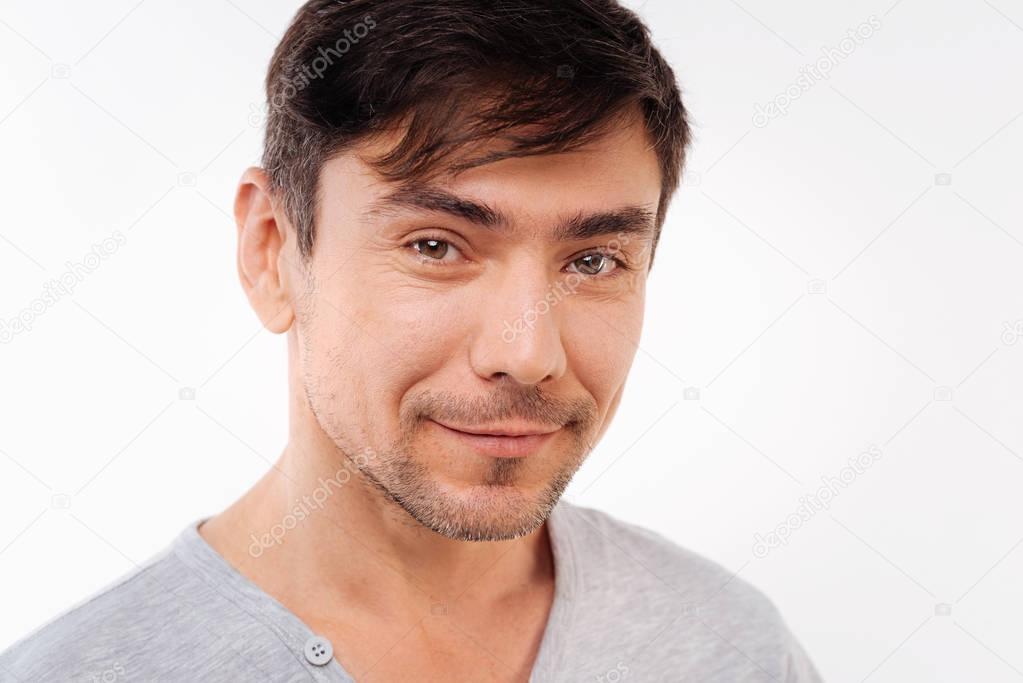 Handsome bristled man posing on white background