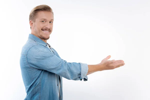 Cheerful man pointing at something with both hands — Stock Photo, Image