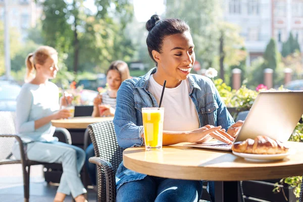 Mulher agradável digitando enquanto sentado em um café — Fotografia de Stock