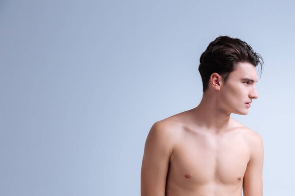 Profile photo of brutal man that standing isolated on grey