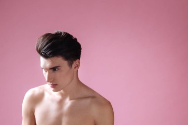 Pembe bir arka plan üzerinde çekici çıplak erkek ayakta