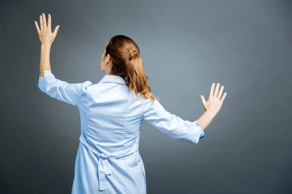 Turned back specialist touching invisible wall — Stock Photo, Image