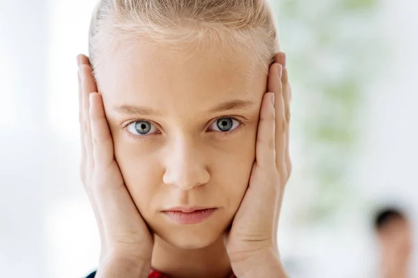 Portrait of a nice pleasant girl holding her cheeks — Stock Photo, Image