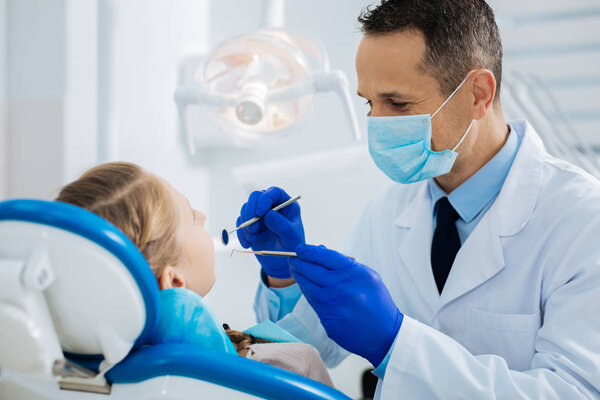 Delighted professional dentist working