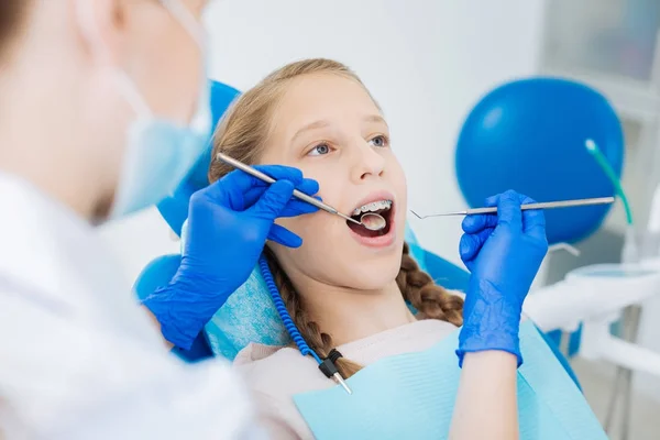 Pleasant blonde girl visiting a dentist — Stock Photo, Image