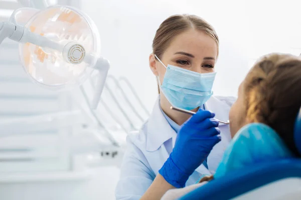 Delighted positive doctor looking at her patient — Stock Photo, Image