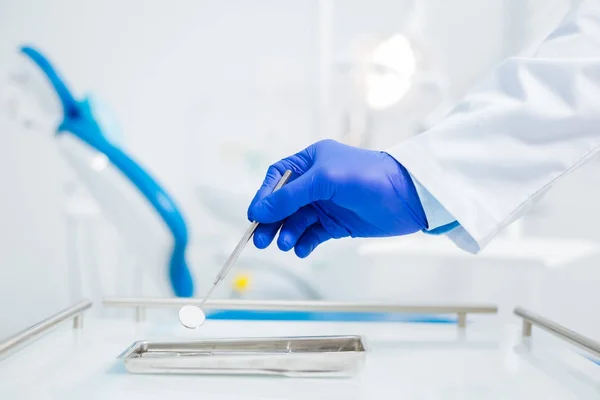 Nice male hand holding a dental mirror — Stock Photo, Image