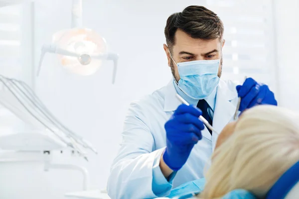 Close up of experienced stomatologist curing his patient — Stock Photo, Image