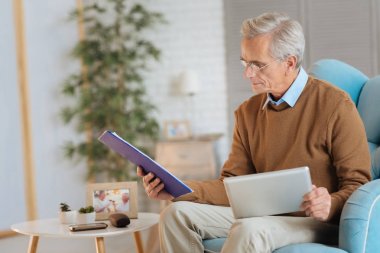 Akıllı belgeler ve touchpad ile çalışan erkeğin emekli