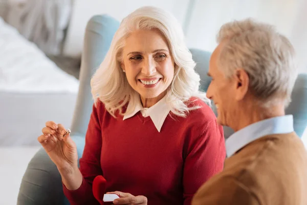 Extremely happy retired couple celebrating their engagement