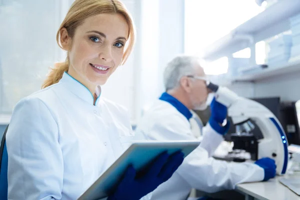 Mulher cientista sorridente vigorosa no laboratório — Fotografia de Stock