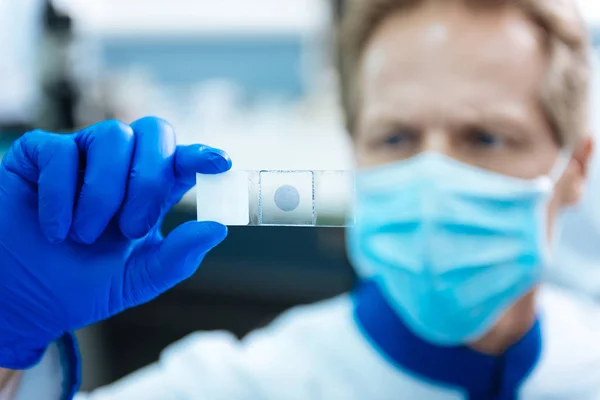 Ernstige wetenschapper observeren van een monster in het lab — Stockfoto