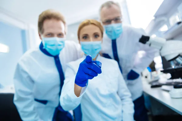 Cheerful researchers looking at the cam and pointing at it — Stock Photo, Image