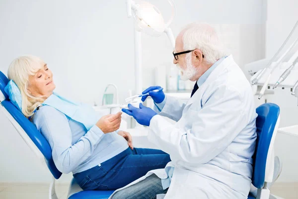 Professioneller Zahnarzt im Prozess der Zahnaufhellung — Stockfoto