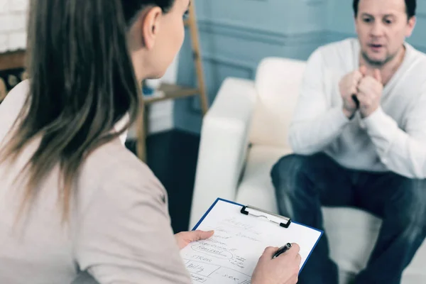 Terapeuta competente escuchando a su visitante — Foto de Stock