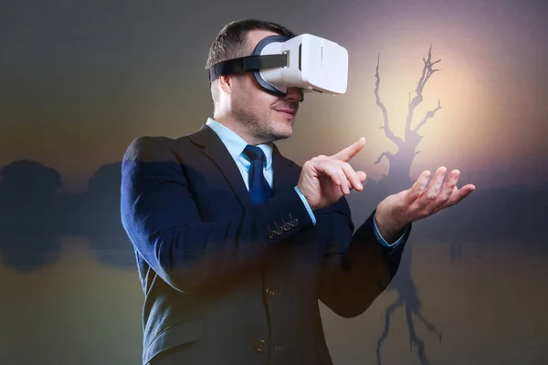 Joyful businessman wearing virtual reality goggles