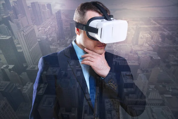 Jovem pensativo tentando óculos de realidade virtual — Fotografia de Stock