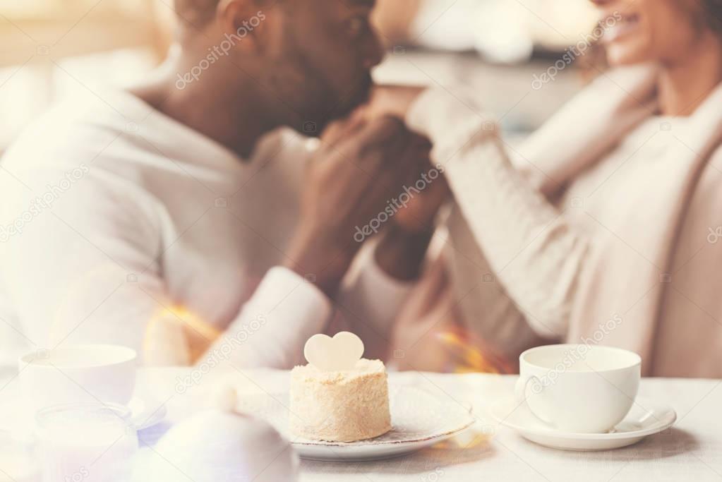 Selective focus of a cake standing near the tea cup