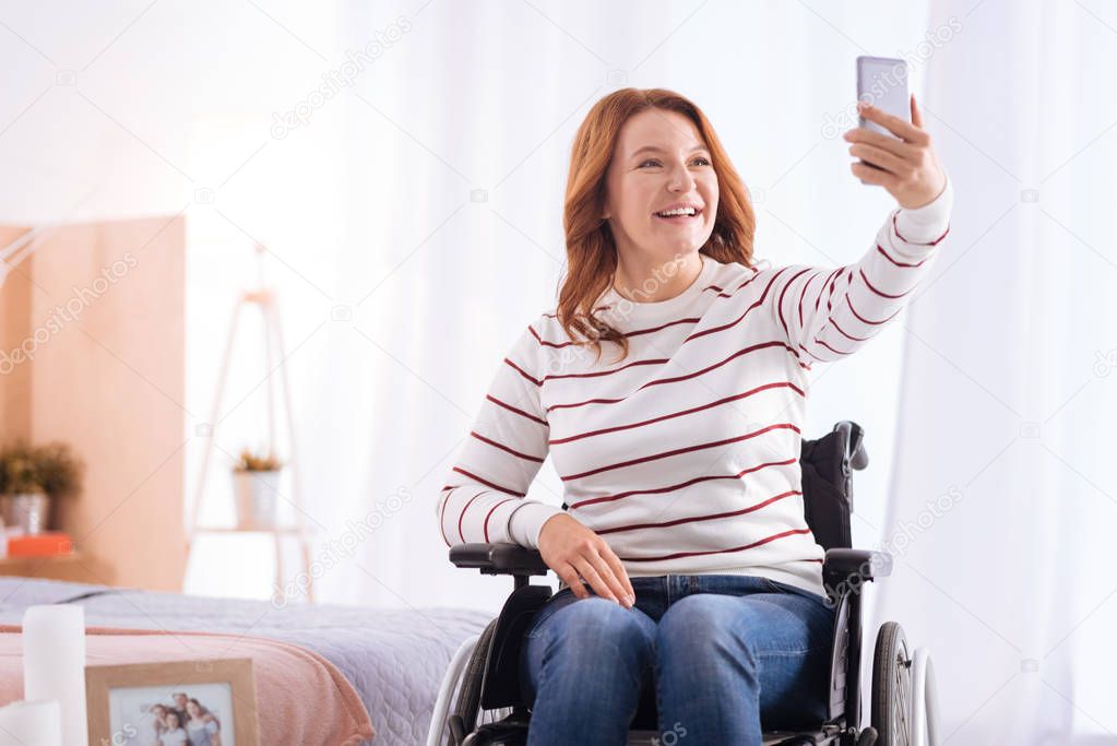 Disabled smiling woman taking photos