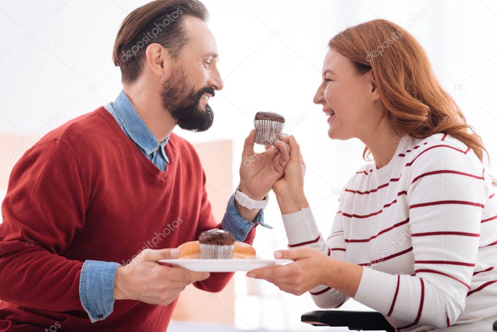 Cheerful man and woman having cookies