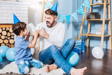 adam ve oğlu oyuncak robotları ile oynuyor