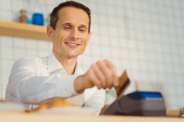 Bir kredi kartı tutan memnun iyi adam