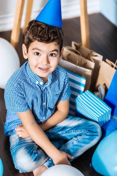 Top view of pleasant birthday boy surrounded by his gifts — Stock Photo, Image