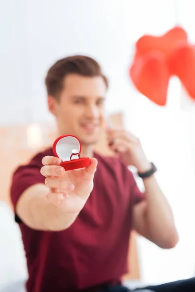 Excited gentleman showing red velvet box with proposal ring — Stock Photo, Image