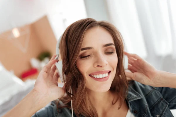 Joven alegre radiante mientras escucha música —  Fotos de Stock