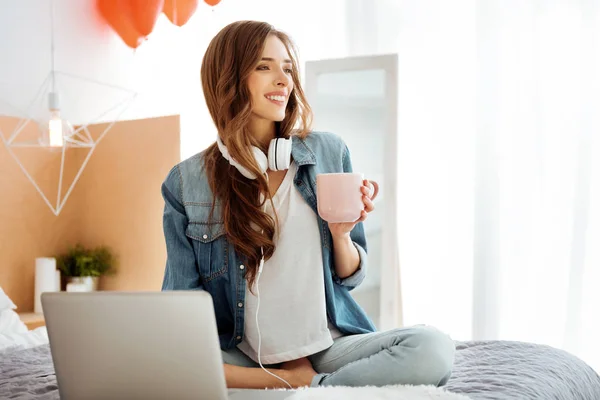 Chica emocionada sonriendo mientras trabajaba en el ordenador portátil — Foto de Stock