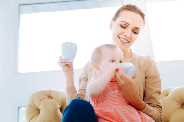 Cute little girl drinking water from the bottle — Stock Photo, Image