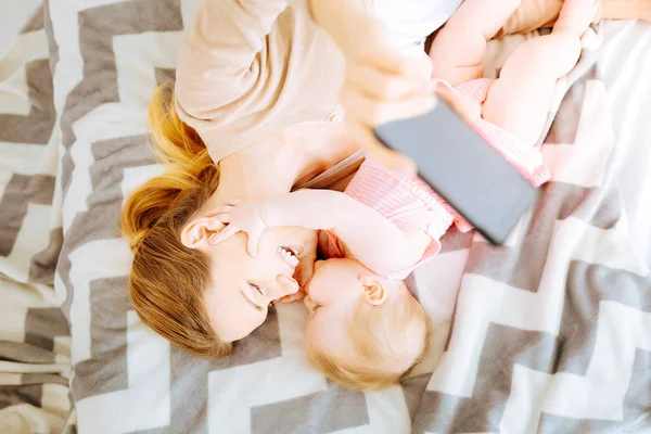 Cheerful mother hugging her little baby — Stock Photo, Image