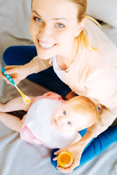 Lovely baby having dinner with a positive parent — Stock Photo, Image