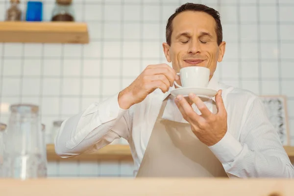 Nice positive man smelling the coffee — Stock Photo, Image