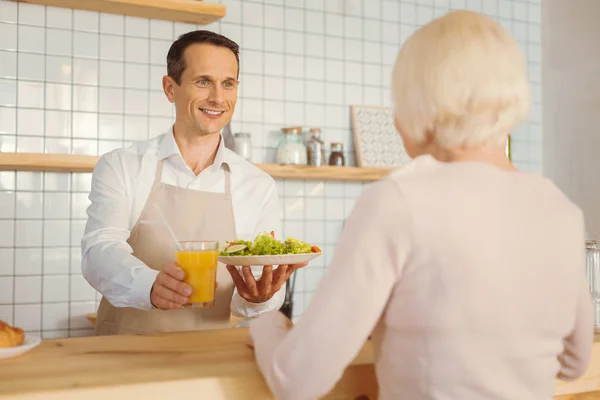 Delighted nice man standing at the counter — Stock Photo, Image