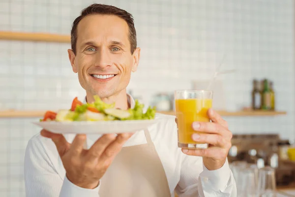 Cheerful happy cook man holding his breakfast — Stock Photo, Image
