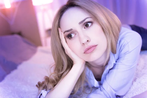 Down in the mouth lady lying on the sofa — Stock Photo, Image