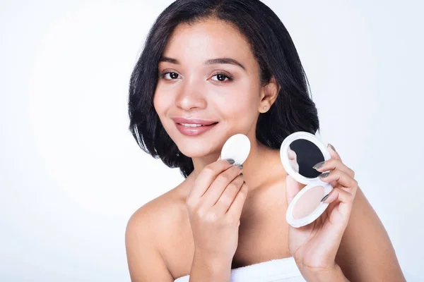 Mujer sosteniendo la cara en polvo y soplo — Foto de Stock