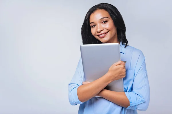 Woman pressing laptop to her chest — Stock Photo, Image