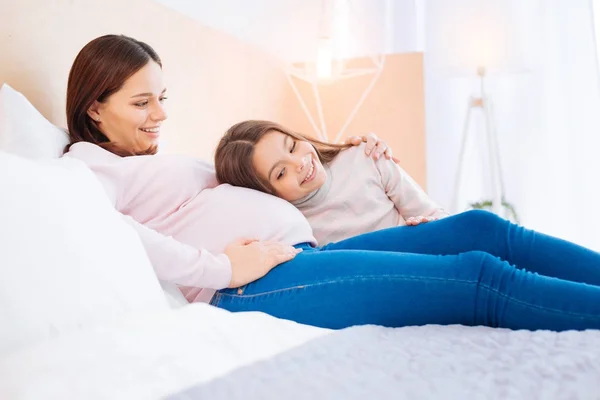 Happy exuberant girl listening to baby in moms  belly — Stock Photo, Image
