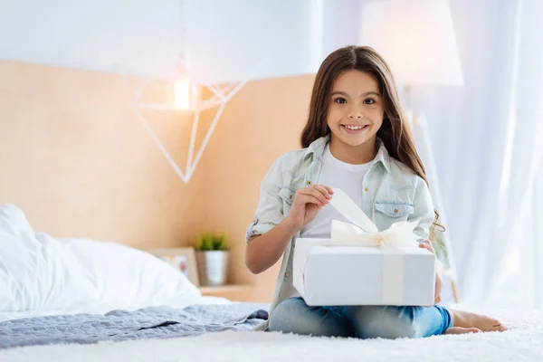 Gelukkig positieve meisje wenst te openen haar cadeau — Stockfoto