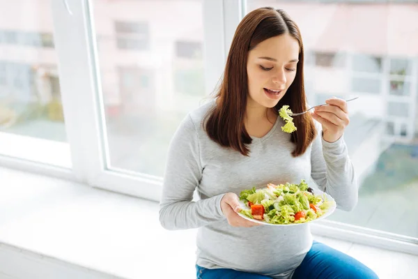 Attractive pregnant  woman wants to bite — Stock Photo, Image