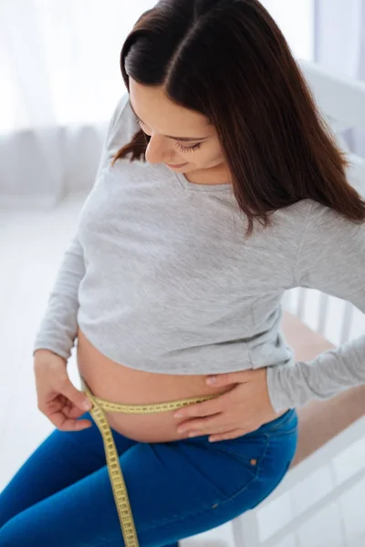 Doordachte zwangere vrouw berekening van centimeters — Stockfoto