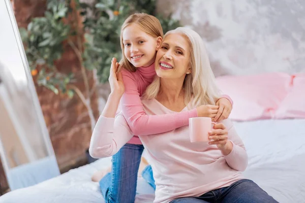 Happy cheerful grandmother and granddaughter being together — Stock Photo, Image