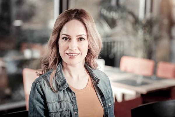 Yeni bir kafe ziyaret ederken memnun arayan akıllı sakin kadın